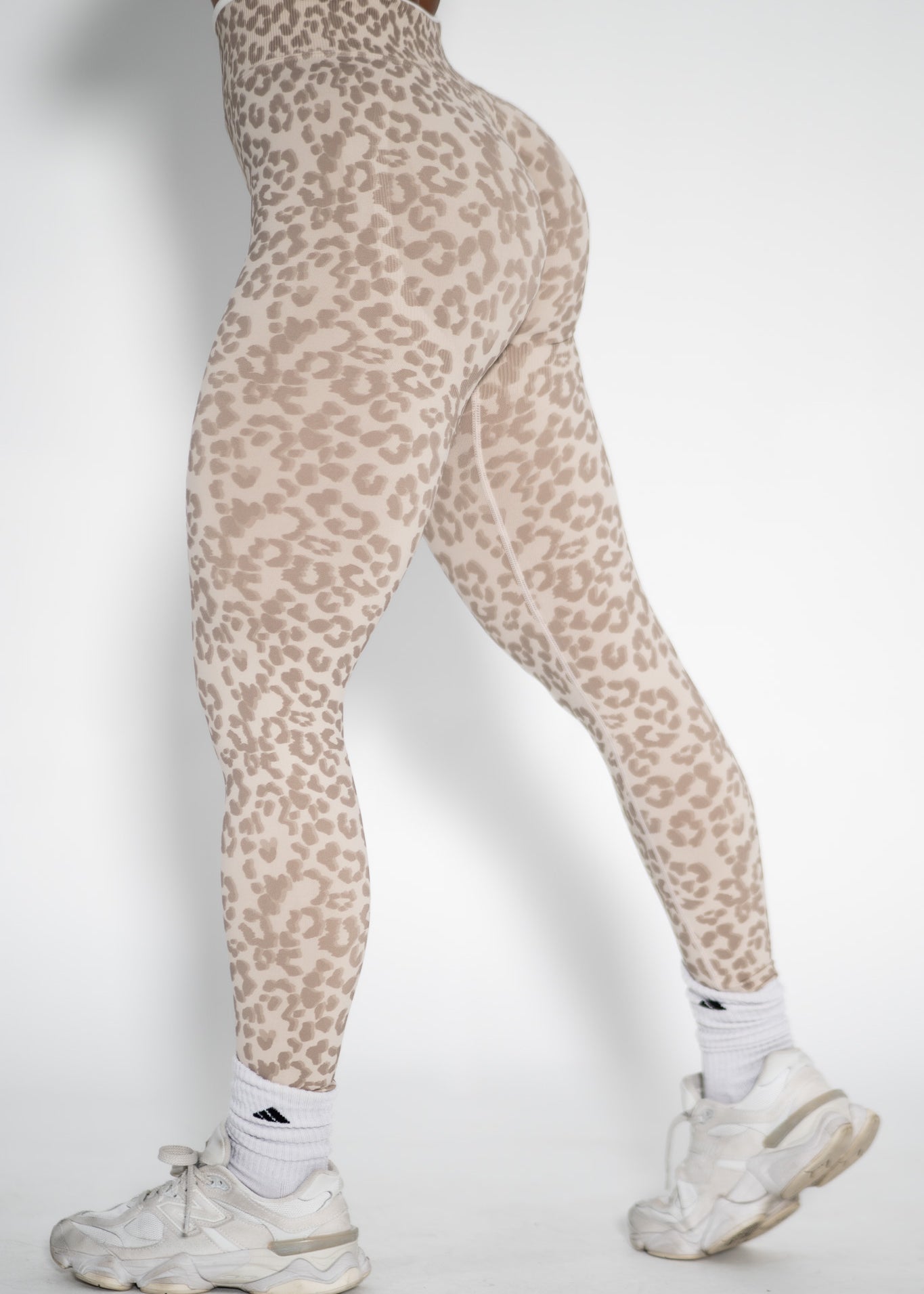 Leopard print leggings worn by a person on a white background
